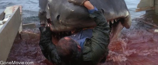 Robert Shaw (Sam Quint) slides down the slippery deck into the open jaws of the monster Great White . He is bitten in half and swallowed whole.